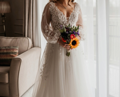 Boho style wedding dress with botanical lace details. lightweight, long sleeve.
