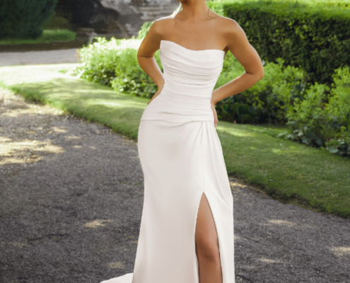 Fit and flare wedding dress in ivory. Strapless with beaded neckline and front split