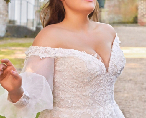Curve wedding dress with all over floral lace and off the shoulder detail. Detachable sleeves available