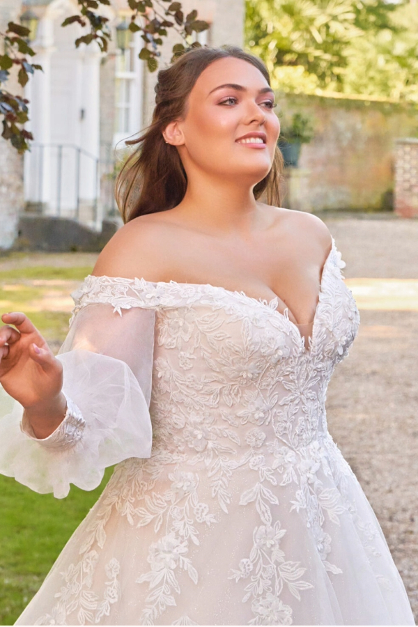 Curve wedding dress with all over floral lace and off the shoulder detail. Detachable sleeves available