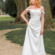 Ivory satin wedding dress with drop shoulder sleeves. A line style with button and lace back detailing.