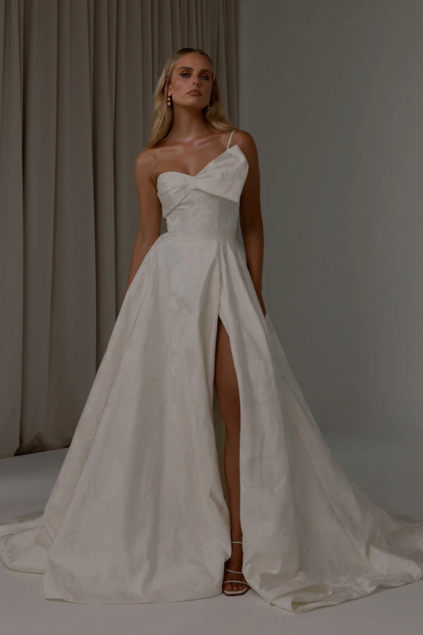 Jacquard satin wedding dress with statement bow and one shoulder by Tania Olsen