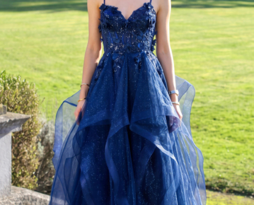 Layered prom dress with glitter and 3d flowers and a lace up bodice